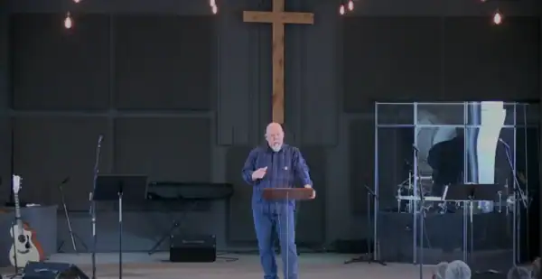 Pastor Hutch in the pulpit preaching on Sunday Morning